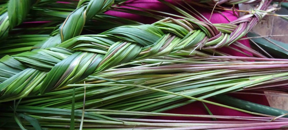 Braids of sweetgrass laid on red cloth